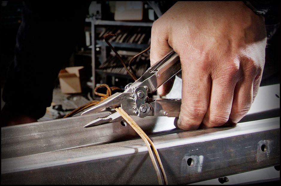 hand using multi-tool to cut wire